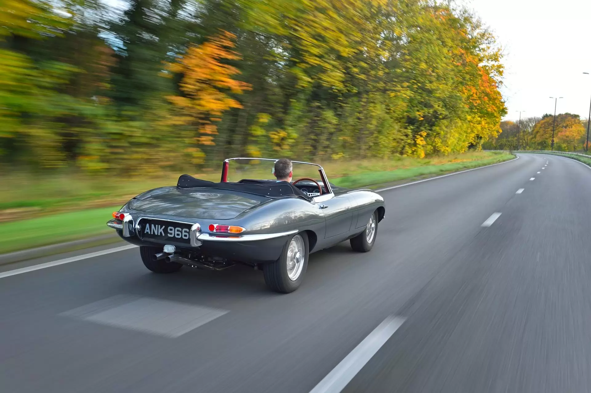 Jaguar classic car driving on the road
