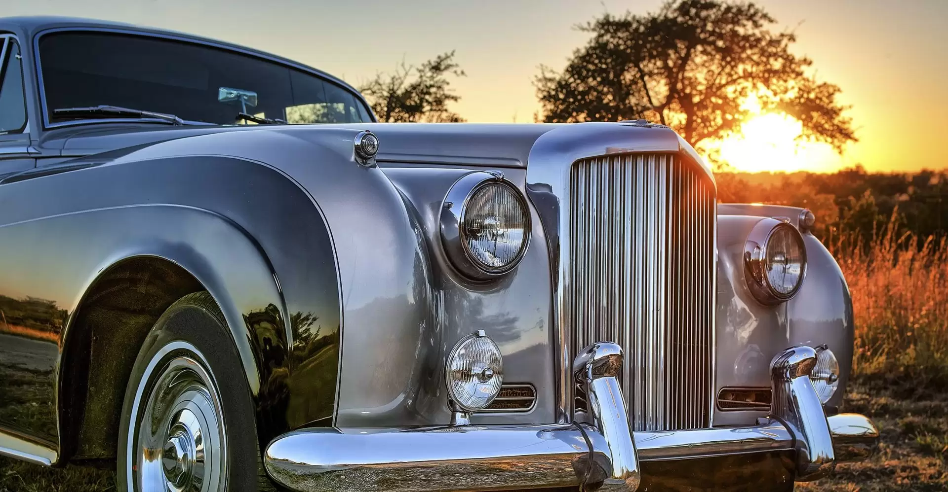 Front side view of classic Bentley at sunset